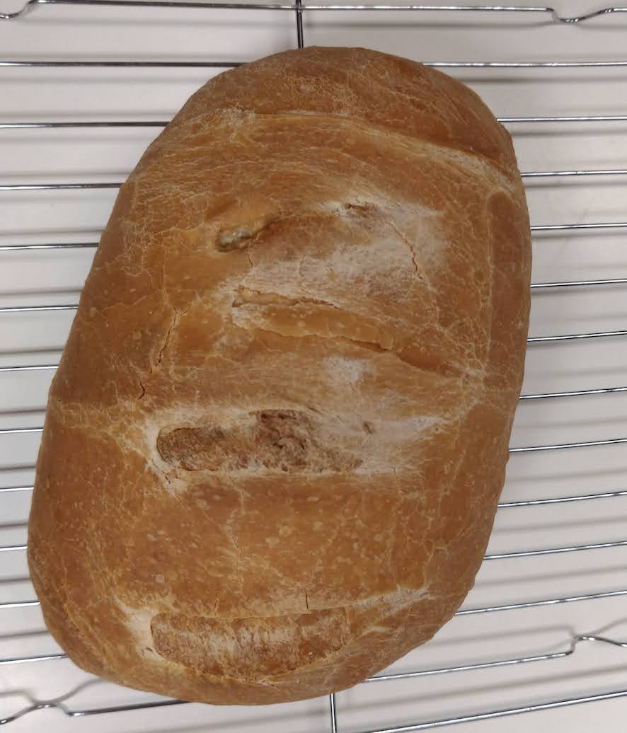 medium-dark oblong loaf with three slashes