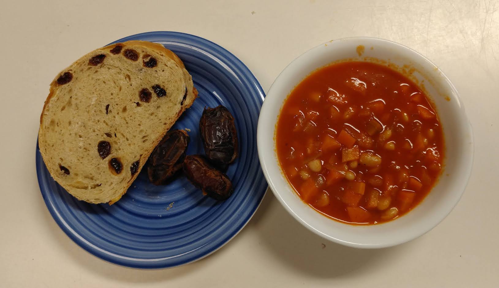 soup with side of bread and dates